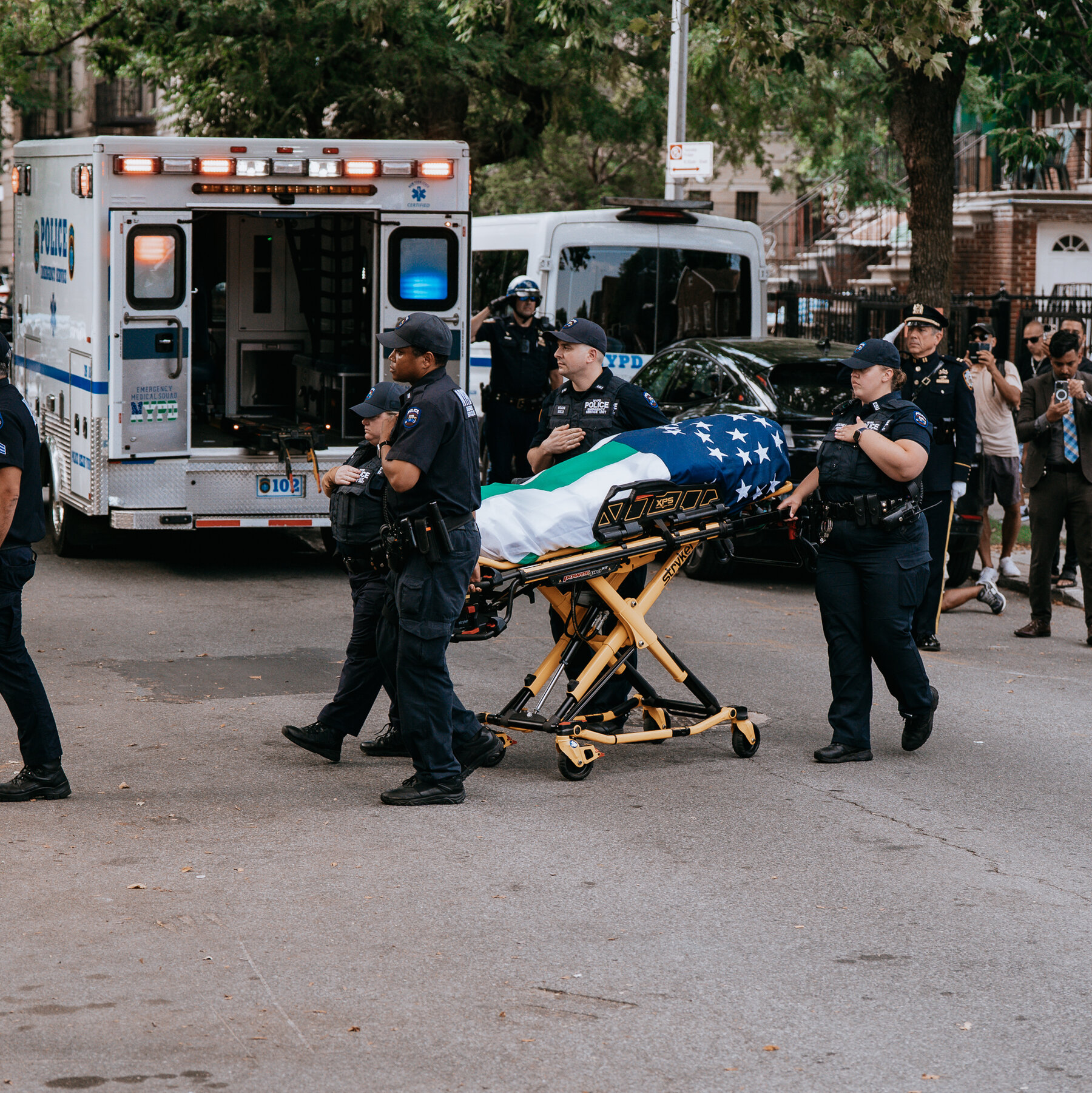 A Fallen Officer’s Flag-Wrapped Body Makes a Somber Journey to a Mosque