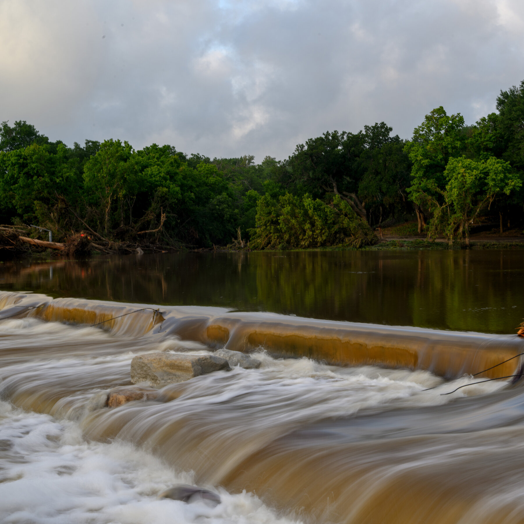Central Texas faces less rain Tuesday, though flood risks persist.