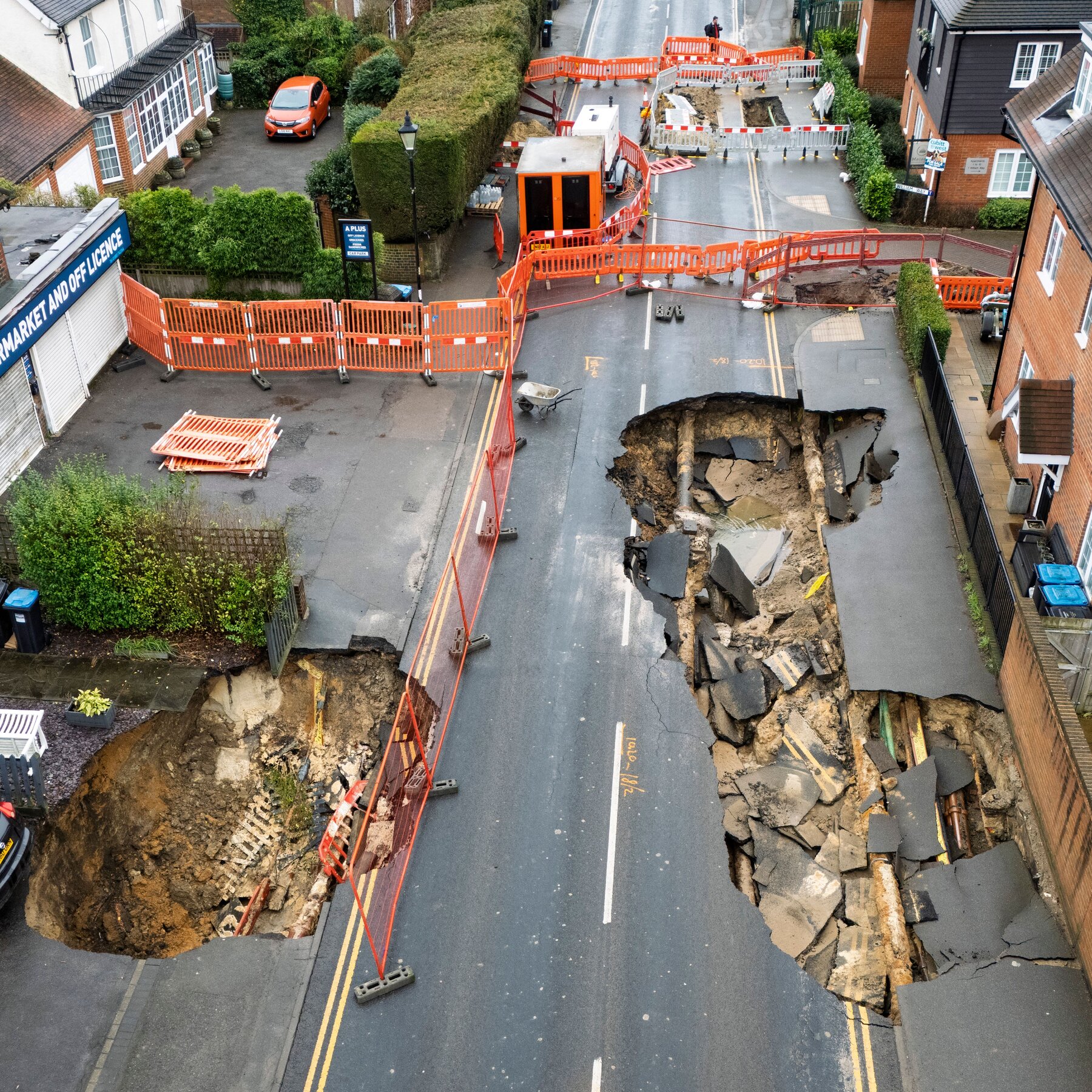 Large Holes Open Up in Surrey, England; Car Teeters on the Edge