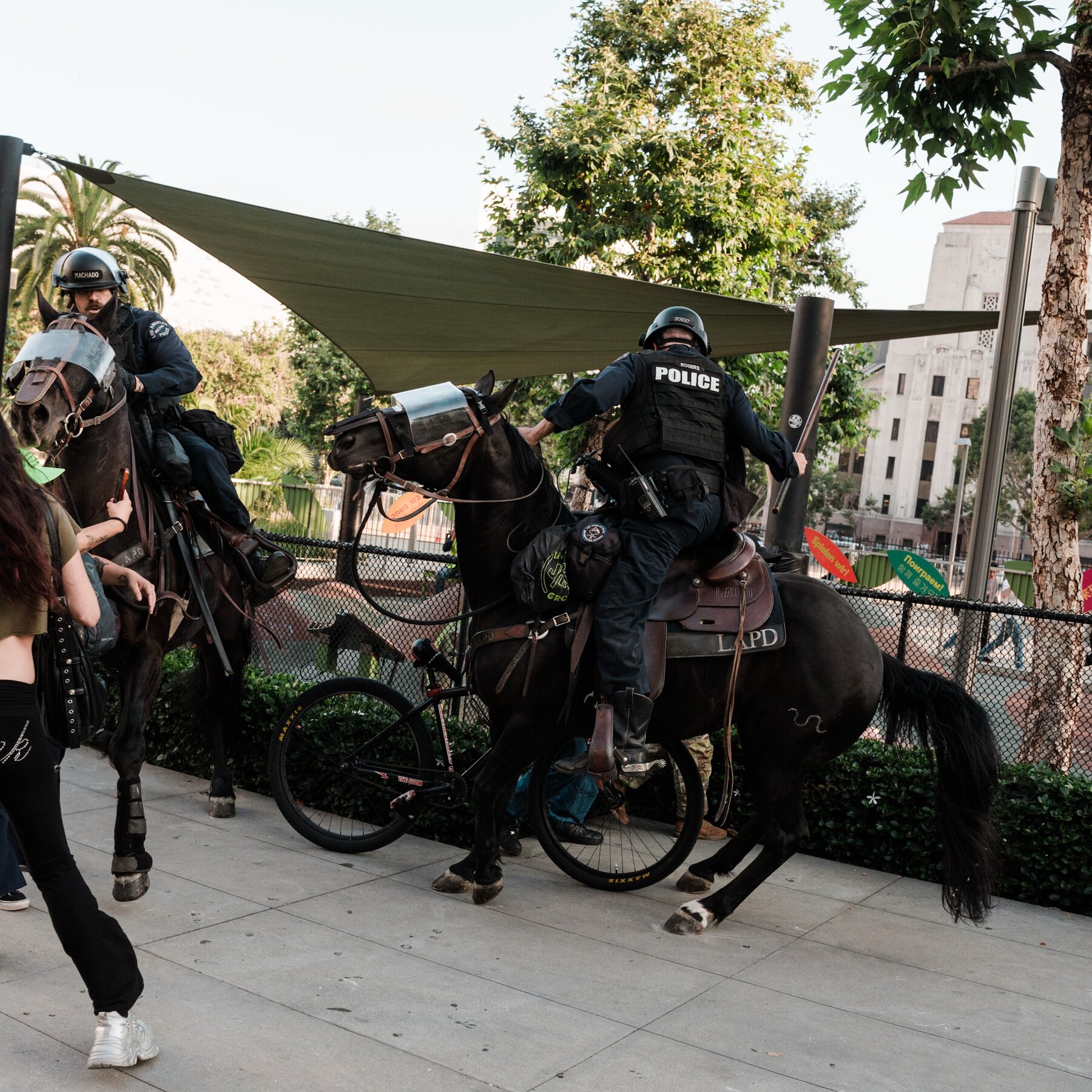 Police on foot and horseback disperse protesters in downtown Los Angeles.